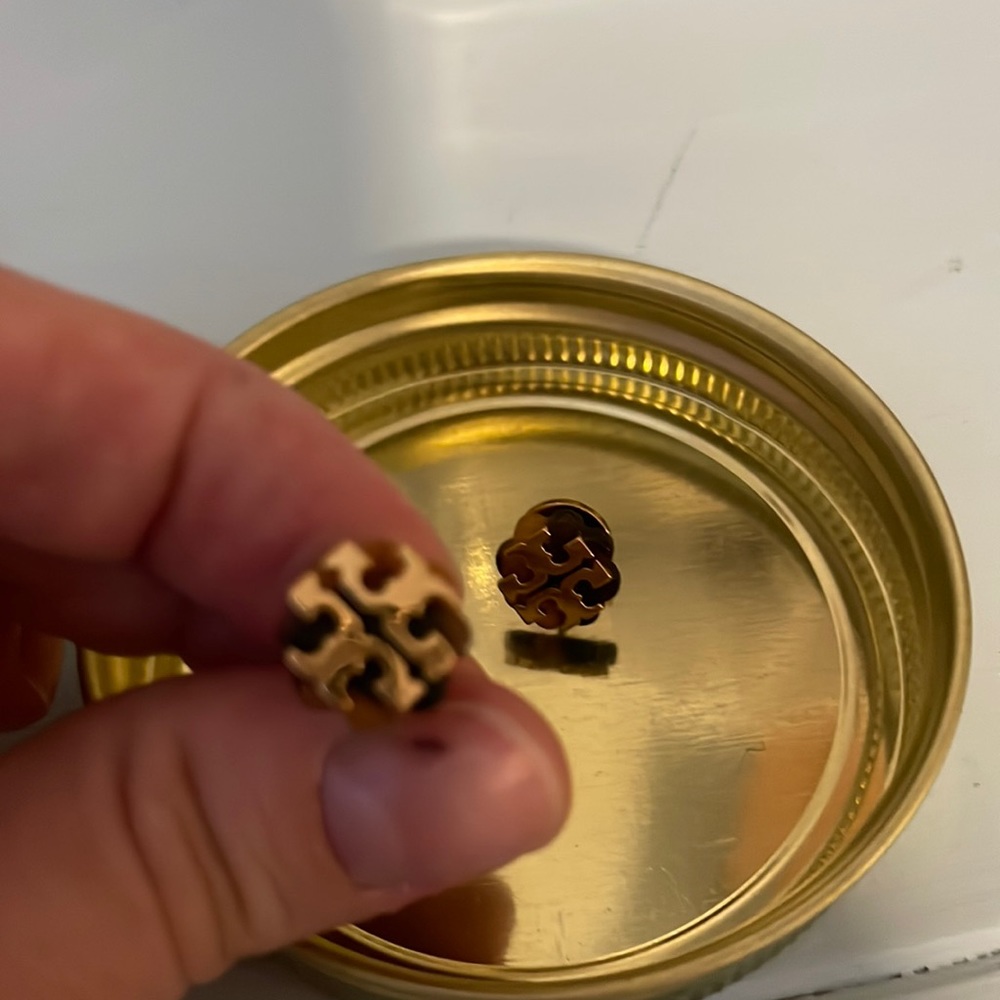 Tory Burch studs with tortoise background